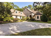 Two-story home with stone accents, landscaped yard, and a large driveway at 1750 Taylor Woods Rd, Deland, FL 32724