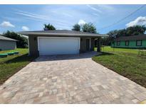 Newly constructed home with a paved driveway and a single car garage at 2220 Church St, Sanford, FL 32771