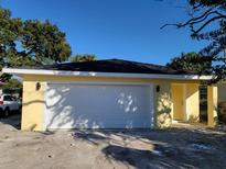New construction home with yellow exterior and white garage door at 2453 Broadway St, Sanford, FL 32771