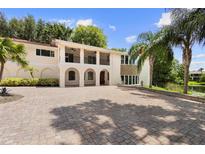 Two-story house with a brick driveway and a balcony at 201 Tranquility Cv, Altamonte Springs, FL 32701