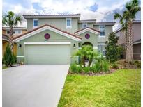 Two-story house with green exterior and landscaping at 5299 Wildwood Way, Davenport, FL 33837