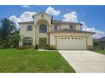 Two-story house with a large yard and two-car garage at 306 Athabasca Pl, Kissimmee, FL 34759