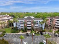Aerial view of building, parking lot, and landscaping at 7652 Whisper Way # 302, Reunion, FL 34747