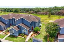 Aerial view of a blue house and surrounding landscape at 435 Caribbean Dr, Davenport, FL 33897