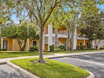 Two-story building with inviting landscaping and parking at 401 New Providence Promenade # 12401, Davenport, FL 33897