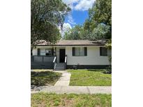 House exterior featuring a white building with gray accents, small porch and yard at 2075 Dixie Ave, Sanford, FL 32771