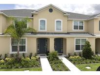 Two-story townhome with front yard landscaping at 1505 Carey Palm Cir, Kissimmee, FL 34747