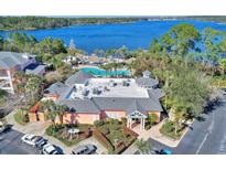 An aerial view of a resort with a pool, restaurant, and lake at 315 Lucaya Loop # 315, Davenport, FL 33897