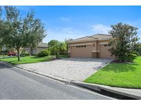 Two-car garage with brick paver driveway at 453 Sorrento Rd, Kissimmee, FL 34759