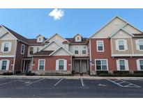Townhouse exterior with parking and appealing curb appeal at 7571 Sunny Dreams Ln, Kissimmee, FL 34747