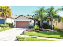 One-story house with attached garage and landscaped front yard at 333 Navarra Ln, Davenport, FL 33837