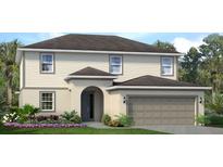Two-story house with beige siding, gray roof, and landscaping at 2288 Sirena Ln, Mount Dora, FL 32757