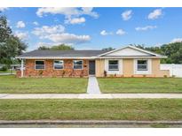 Newly renovated brick and stucco ranch home with a well-maintained lawn at 274 N Ranger Blvd, Winter Park, FL 32792