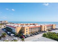 Aerial view of beachfront condo building with parking and ocean views at 3801 S Atlantic Ave # 321, New Smyrna Beach, FL 32169
