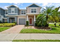 Two-story house with two-car garage and landscaping at 889 Park Grove Ct, Orlando, FL 32828