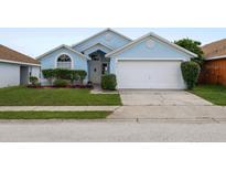 Light blue single story home with a grassy yard at 619 Cheshire Way, Davenport, FL 33897