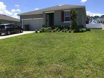 Single-Gathering home with a two-car garage and manicured lawn at 8073 Cherrystone St, Leesburg, FL 34748