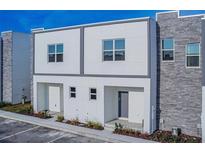 Modern two-unit building with gray and white exterior at 387 Famagusta Dr, Davenport, FL 33896