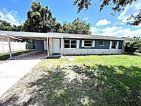 Newly renovated home with carport and well-maintained lawn at 520 Avenue L Se, Winter Haven, FL 33880