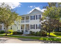 Two-story house with front porch and landscaping at 114 Eastpark Dr, Celebration, FL 34747