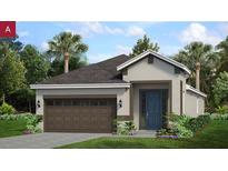 New home exterior with brown garage door and a blue front door at 168 Duckweed Ave, Fruitland Park, FL 34731