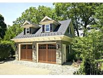 Charming two-car detached garage with stone accents and dormer windows at 925 14Th St, Saint Cloud, FL 34769