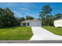 Newly built one story home with a large yard and driveway at 34 Dogwood Dr Crse, Ocala, FL 34472