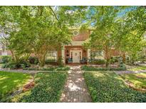 Brick home with lush landscaping and inviting front porch at 1650 Lakehurst Ave, Winter Park, FL 32789