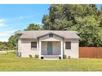 Charming single-story home with a teal door and wood fence at 1500 N Clearview Ave, Deland, FL 32724