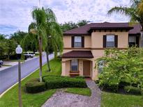 Two-story house with brown roof and landscaping at 744 La Mirage St, Davenport, FL 33897