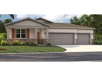 Three-car garage home with stone accents at 12922 Trovita Dr, Grand Island, FL 32735