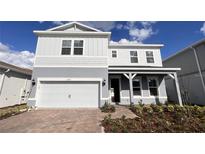 Two-story home with gray and white exterior, two-car garage at 10331 Parkview Reserve Ln, Orlando, FL 32836