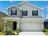 Two-story house with neutral siding, two-car garage, and landscaping at 4379 Sagefield Dr, Saint Cloud, FL 34773