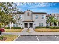 Two-story townhome with a well-manicured lawn at 4838 Romeo Cir, Kissimmee, FL 34746