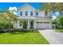 Two-story farmhouse style home with white siding, gray roof, and a paved driveway at 1840 Biscayne Dr, Winter Park, FL 32789