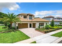 Two-story house with tile roof, double garage, and landscaped yard at 10193 Brocksport Cir, Gotha, FL 34734