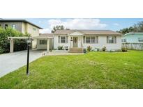 Charming single-story home with a carport and well-maintained lawn at 1338 Vassar St, Orlando, FL 32804