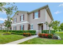 Two-story townhome with landscaping and walkway at 1624 Hawksbill Ln, Saint Cloud, FL 34771