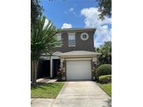 Two-story house with a white garage door at 10420 Kiplinger Ln # 238, Orlando, FL 32829