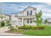 Two story house with landscaping and driveway at 1870 Sawyer Palm Pl, Kissimmee, FL 34747