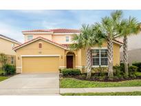 Two story house with a two car garage and landscaping at 6047 Broad Oak Dr, Davenport, FL 33837