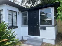 Front view of a charming bungalow with black door at 1639 Silver Star Rd, Orlando, FL 32804