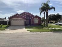 Two-story house with a two-car garage and manicured lawn at 514 Tree Shore Dr, Orlando, FL 32825