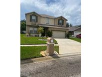 Two-story house with a two-car garage and manicured lawn at 2531 Lyndscape St, Orlando, FL 32833
