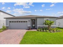 Single story home with gray siding and brick accents at 772 Griffon Ave, Lake Alfred, FL 33850