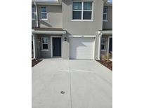 Townhouse with attached garage and driveway at 672 Moscato Dr, Holly Hill, FL 32117