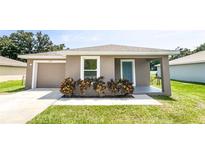Charming house exterior with gray siding, garage, and landscaping at 888 Old Winter Haven Rd, Auburndale, FL 33823