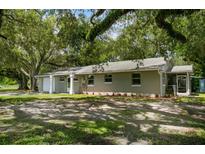 Ranch home with a large yard and mature trees at 1406 S Hoagland Blvd, Kissimmee, FL 34746