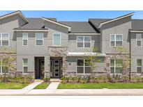 Modern two-story home with stone accents at 1676 Tropical Palms Cir, Kissimmee, FL 34747