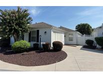 Single-story house with garage and landscaped front yard at 1631 Edisto Ln, The Villages, FL 32162